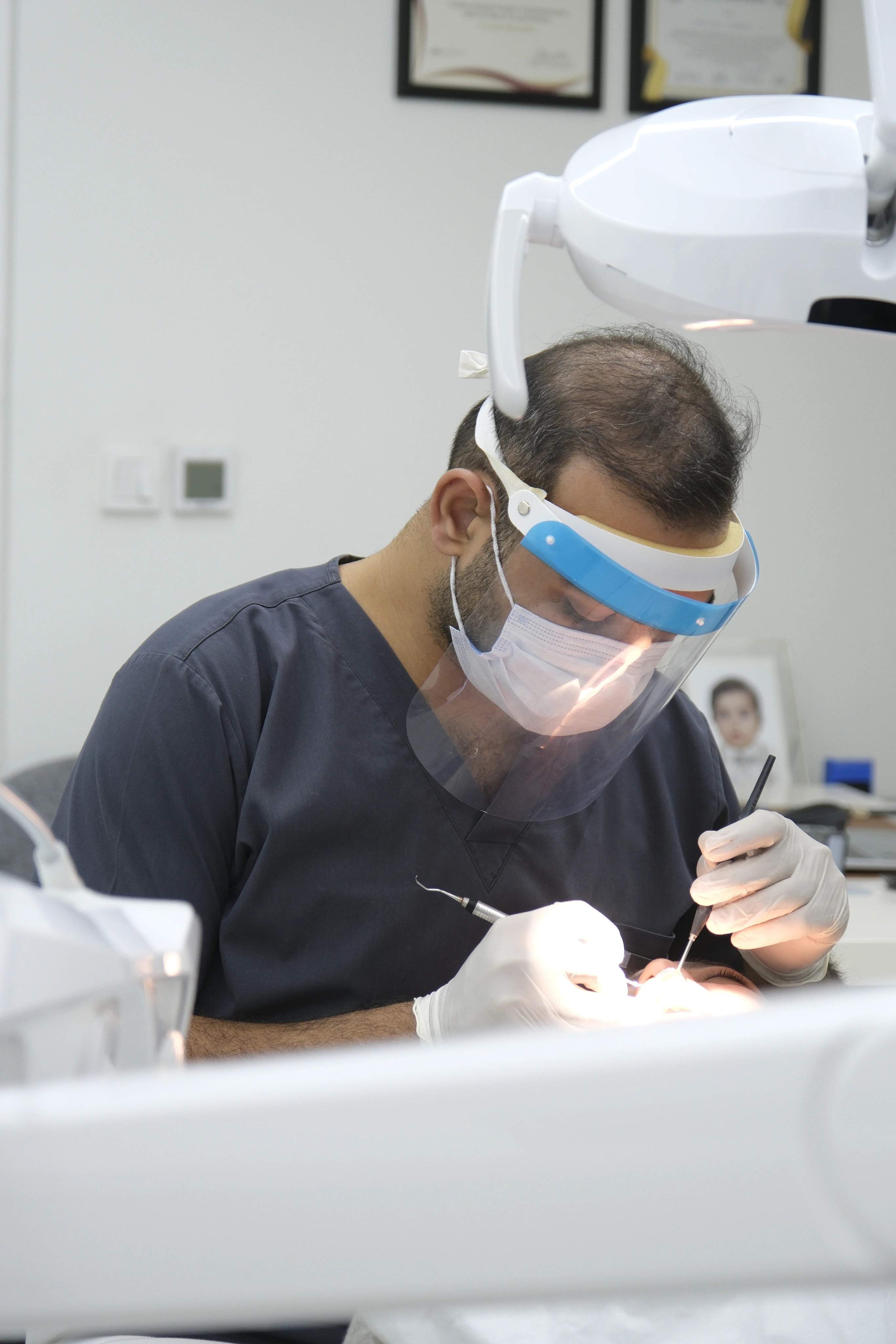 Curisline İzmir dentist carefully treating a patient